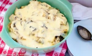 A bowl of roasted cabbage topped with cheese sauce.