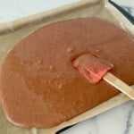 Smoothing batter into a the pan with a rubber spatula.
