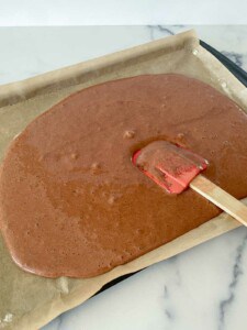 Smoothing batter into a the pan with a rubber spatula.