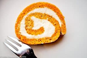 A slice of pumpkin roll showing its layers.