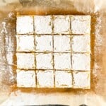 Classic lemon bars cut in squares and sprinkled with powdered sugar.
