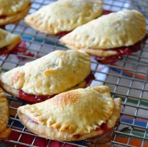 Jam hand pies resting on a cooling tray.
