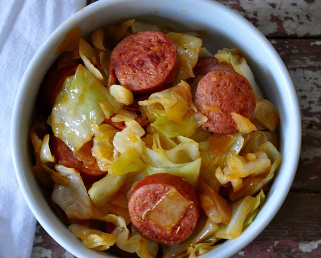 This recipe for Smothered Cabbage with Smoked Sausage was something I was pointed towards a few years ago when I was inundated with bountiful cabbage. #cabbagerecipe #southerncabbage #cabbagerecipes #quickdinnerrecipes #dinnerrecipe