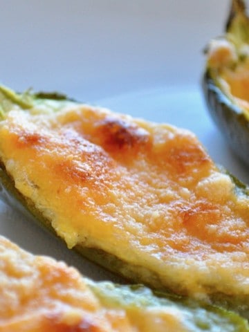 This recipe for Baked Jalapeño Poppers has it ALL going on. First it's LOW CARB but then it has cheddar cheese, smooth cream cheese, crispy topping, all served up in a jalapeño. And you can make them in your OVEN. #keto #lowcarb #lowsugarrecipes #lowsugarsnacks #lowsugartreats #lowsugardiet #ketosnacks #ketorecipe #jalapenopopper #bakedjalapenopopperrecipe #lowcarbsnacksforthebiggame