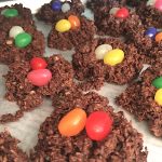 Toasted coconut chocolate nests with colorful jellybeans as eggs.
