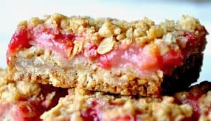 Close-up photo of strawberry rhubarb oatmeal bars showing its delicious layers!
