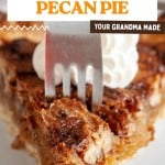 A fork presses into a slice of old fashioned pecan pie topped with a dollop of whipped cream, an easy pecan pie recipe choice.