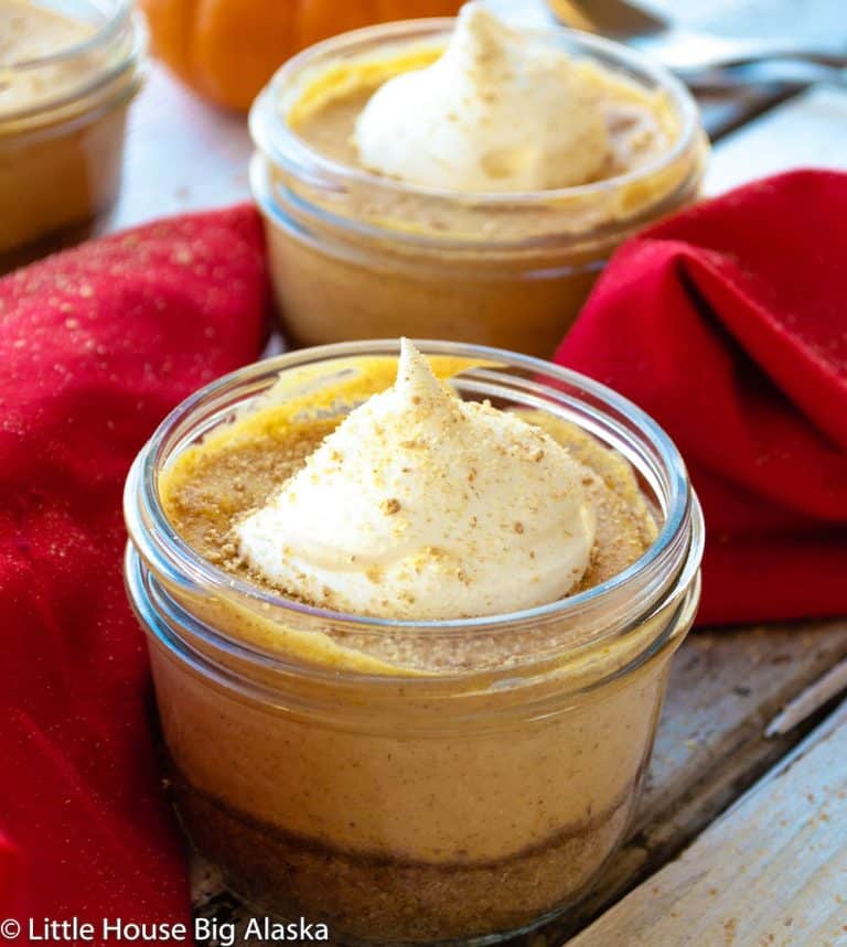 A jar full of pumpkin cheesecake.