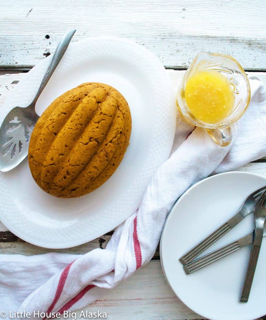 Classic steamed Victorian pudding Pumpkin pudding with a jar of vanilla hard sauce on the side.