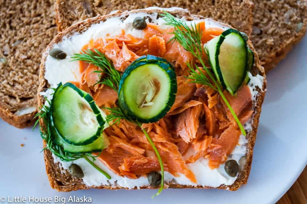 perfect Smørrebrød with salmon cream cheese dil capers and cucumbers--an open face sandwich