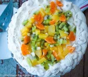Fruits on the top of a vegan pavlova.