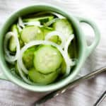 A bowl of cucumber onion salad, a simple summer dish.