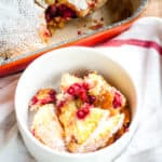Raspberry buckles scooped out from the pan into a bowl.