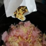 Adding the secret ingredient to the crock pot chicken cordon bleu.