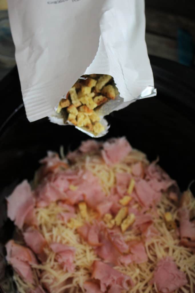 adding the secret ingredient to the crock pot chicken cordon bleu 