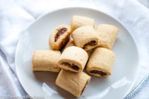 Stack of fig rolls on a white plate.
