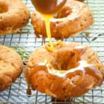 Caramel drizzled over the apple doughnuts.