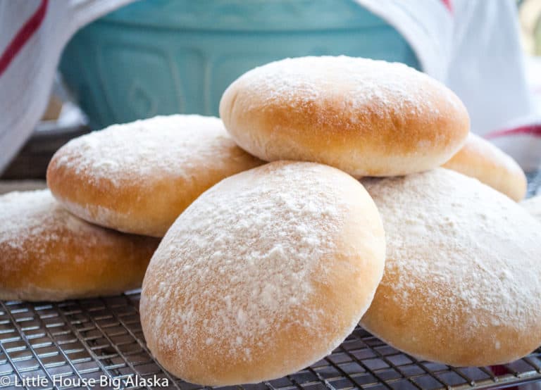 Floury baps in a cooling rack.