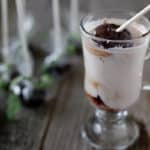 Hot chocolate on a stick dipped into a glass of milk.