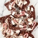 Candy can hot cocoa bark in a marbled surface.