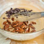 Stirring in the chocolate chips and fresh pecans into the pie mixture.