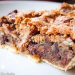 Close-up photo of old-fashioned chocolate pecan pie slice showing its delicious inside.