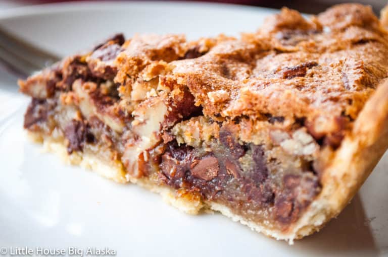 Close-up photo of old-fashioned chocolate pecan pie slice showing its delicious inside.