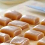 Homemade caramels in a wooden board.