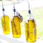 Three bottles of rosemary infused olive oil.