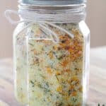 A jar full of homemade orange thyme flavored herb salt.
