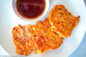 Kimchi pancakes served with sauce on the side.