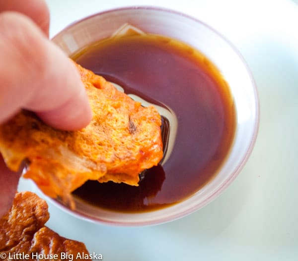 a good vegetarian kimchi pancake dipped in sauce for an easy vegetarian meal