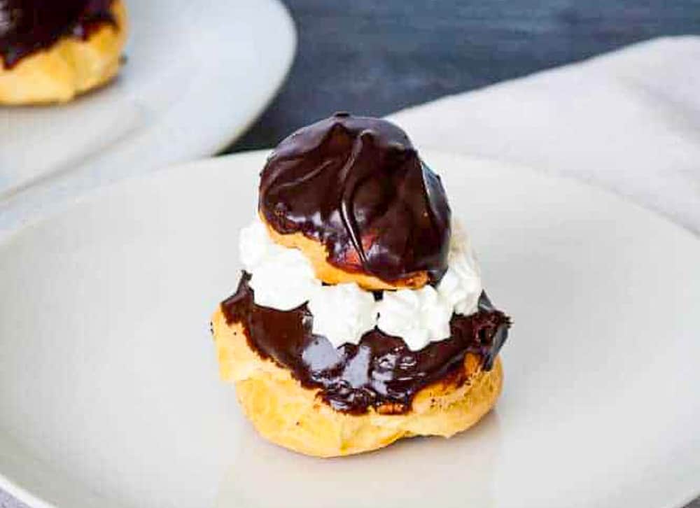 Religiuese choux bun on a plain white plate.