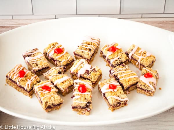 Cherry bars topped with a drizzle of cherry icing.