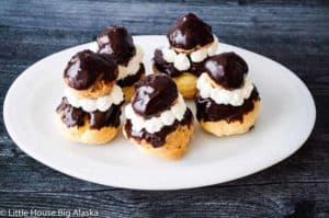 Religieuse cream puffs in a white plate.