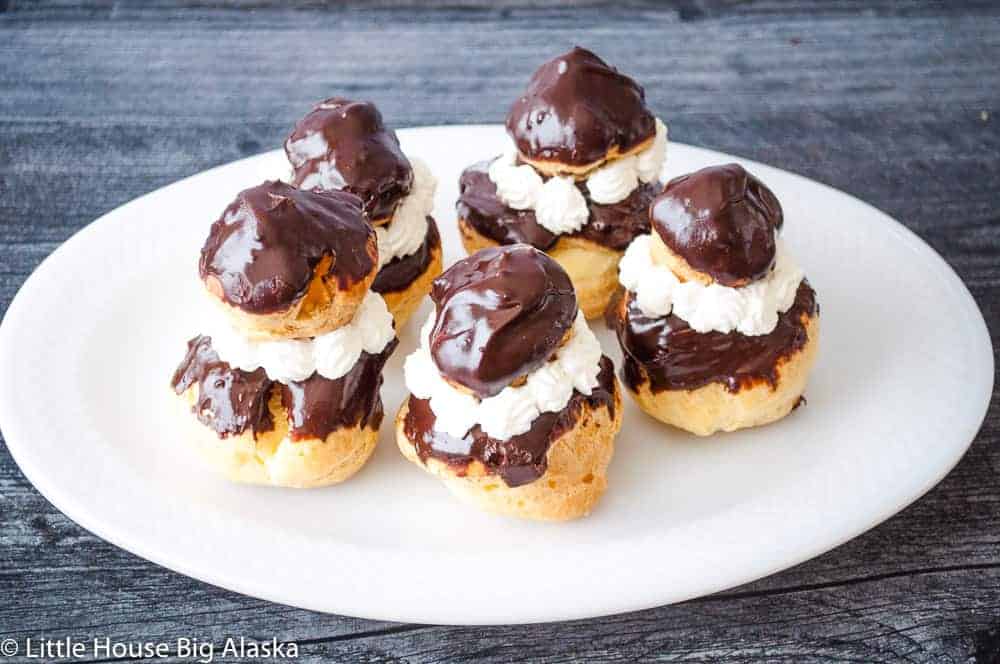 Religieuse cream puffs in a white plate.