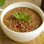A bowl of hearty brown lentil soup made in an Instant Pot.