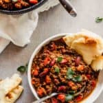 Bowl of madras lentils served with a pita bread.