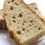 Close-up photo of a sourdough einkorn bread slice, highlighting its airy crumb and chewy crust.