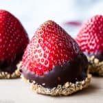 Cheesecake stuffed strawberries in a wooden surface.