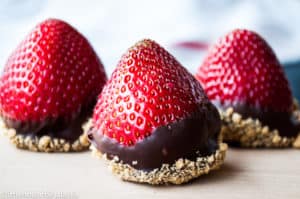 Cheesecake stuffed strawberries in a wooden surface.
