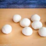 Dough divided into 12 equal balls.