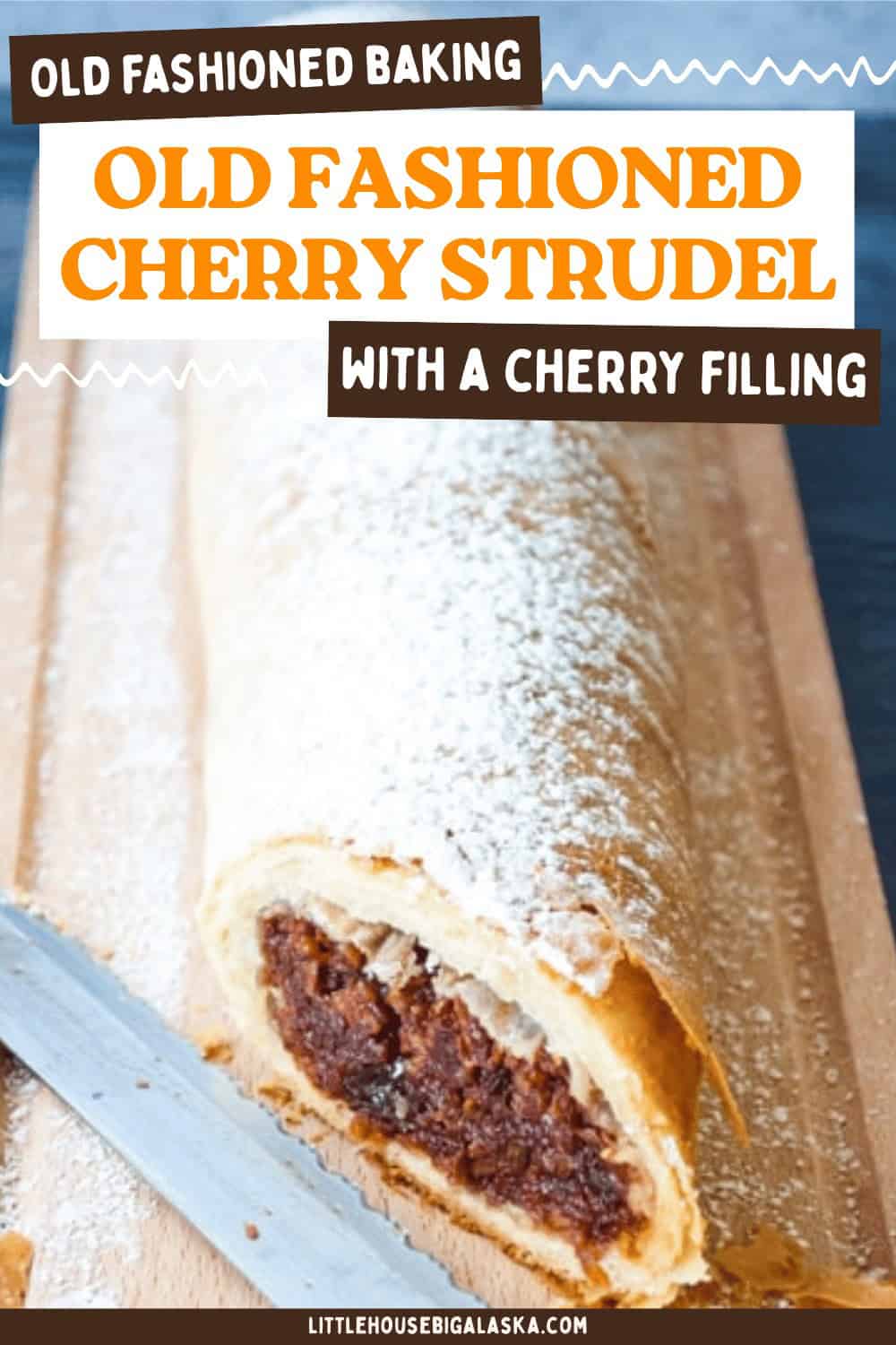 A classic Cherry Strudel, dusted with powdered sugar, sits on a wooden board next to a serrated knife. The text describes it as an old fashioned cherry strudel made from a traditional strudel recipe, featuring a rich, fruity cherry filling.