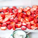 Vanilla sugar sprinkled over the strawberries in the baking sheet.