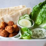 All the toppings for a fresh falafel sandwich.