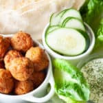 All the toppings for a fresh falafel sandwich.