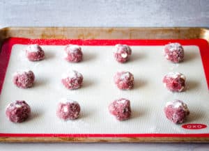 Red velvet cake mix cookies arranged in a cookie sheet ready to bake.