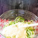 Batter added to the bowl of zucchini noodles.