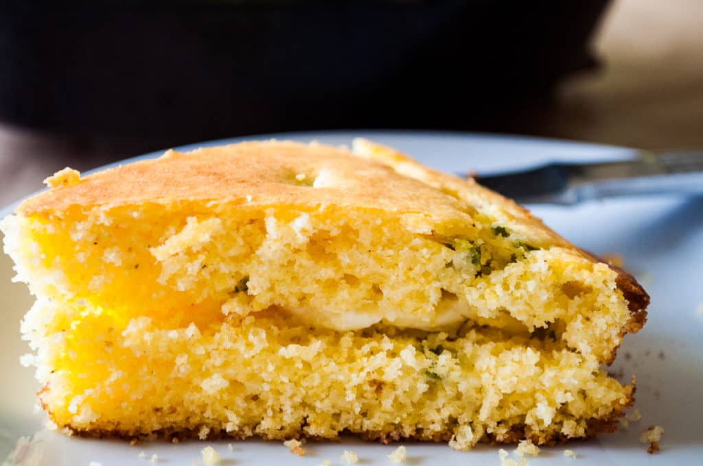 Fresh butter on a slice of bread.