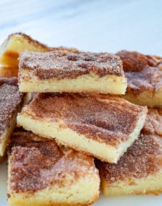 Three snickerdoodle bars on top of a pile of cookies.